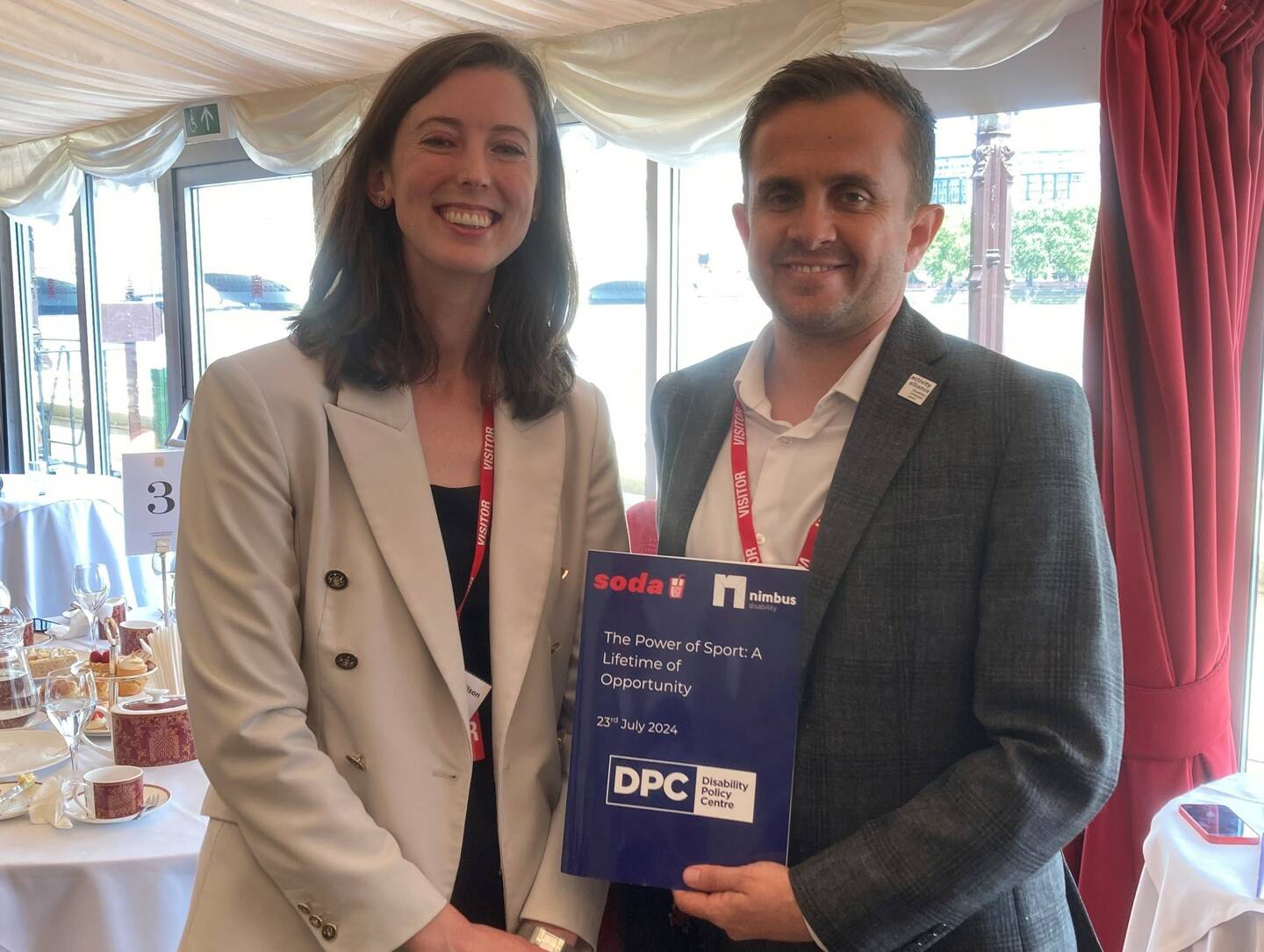 Adam Blaze, CEO of Activity Alliance, and Chloe Schendel-Wilson, Co-Founder, The Disability Policy Centre hold the The Power of Sport: A Lifetime of Opportunity report.