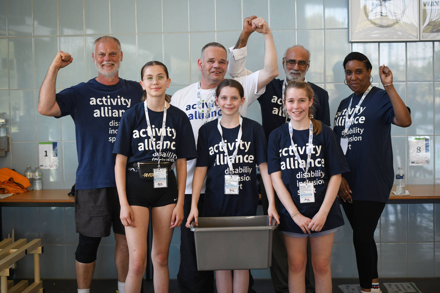 Volunteers at an event waving at the camera